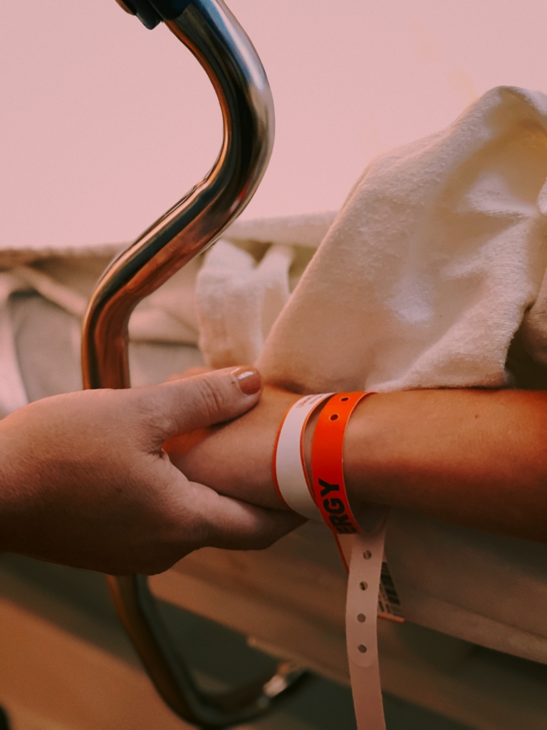 Holding hands at hospital bed