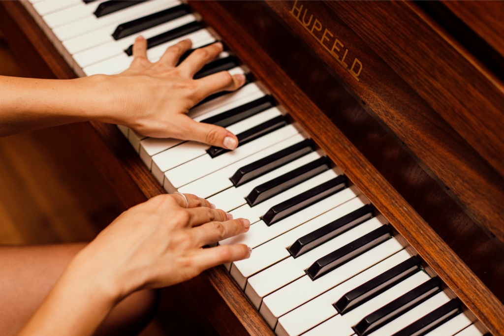 Person playing the piano at a funeral in New Zealand