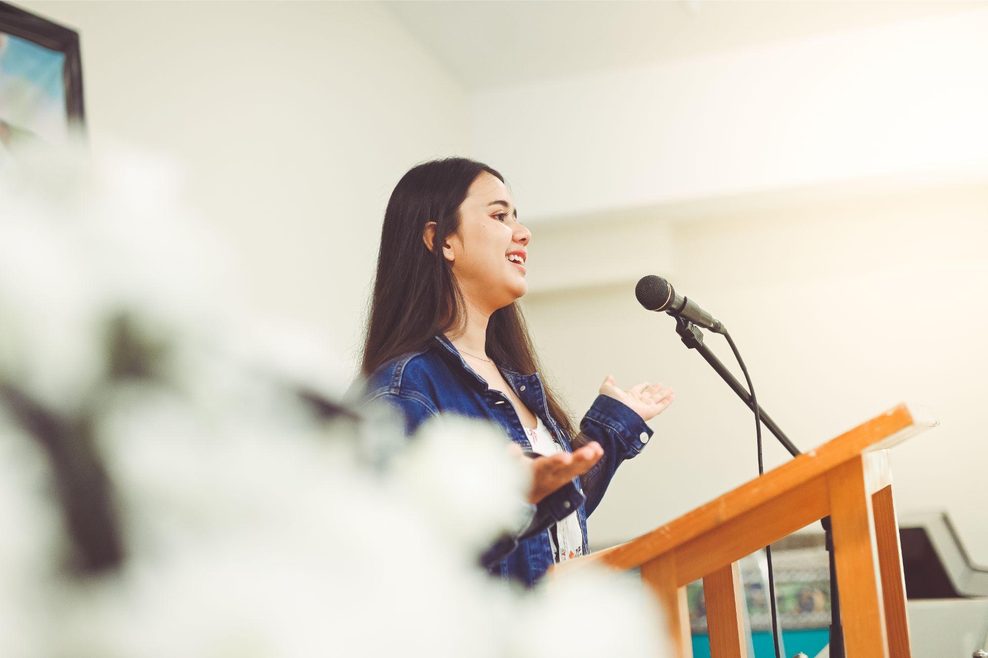 Woman giving a eulogy at a funeral in New Zealand