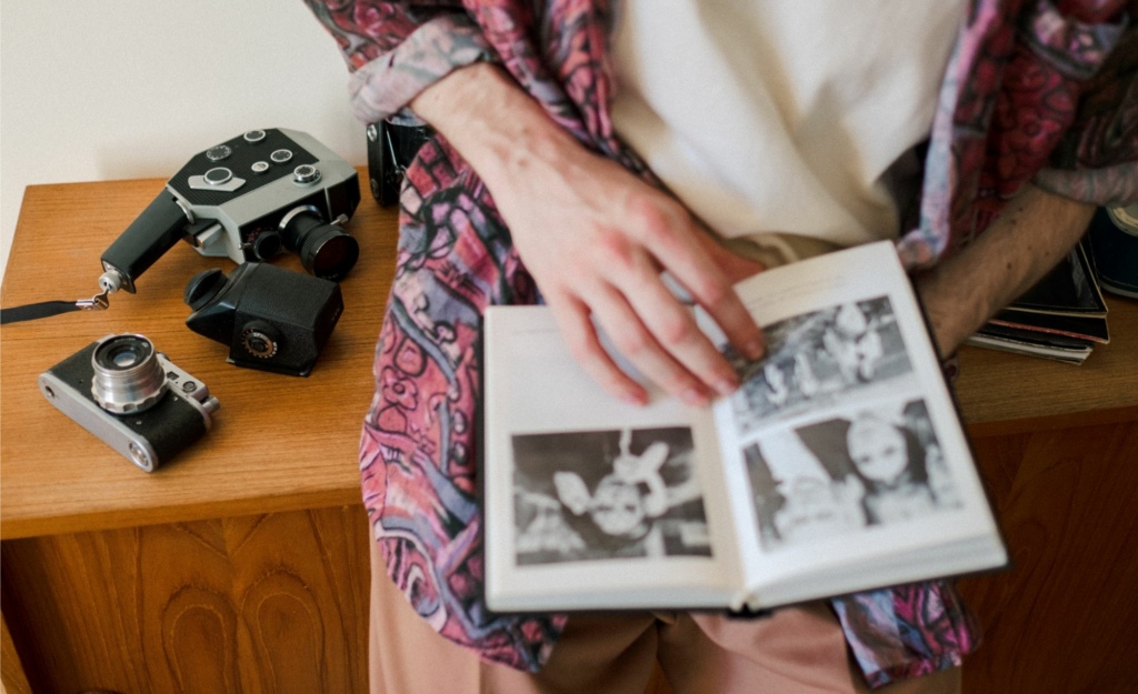 Person sat on table looking through a photo album