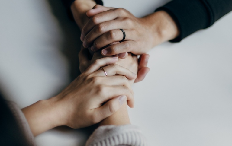 Two people holding hands