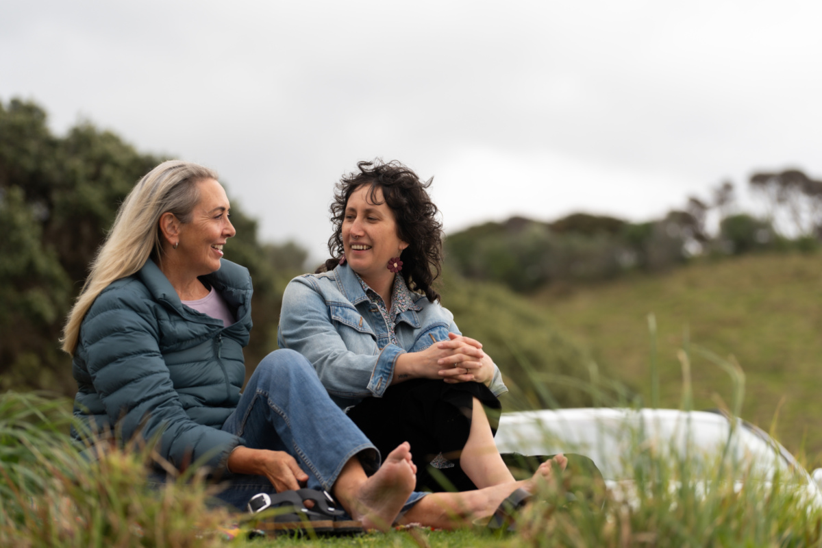 Two friends talking in the grass