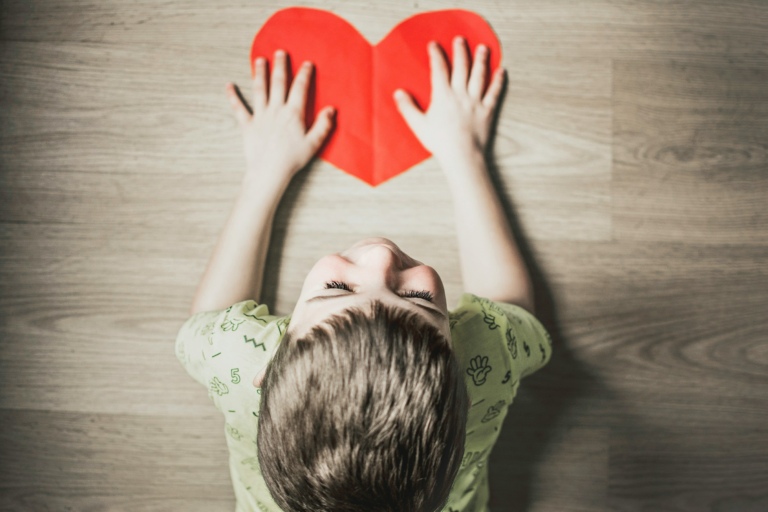Child holding paper heart