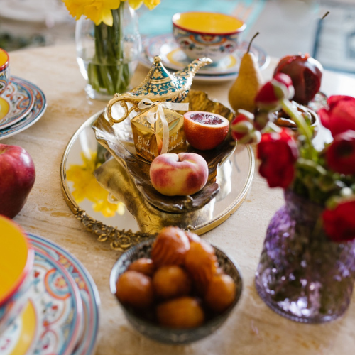 Food spread on a table with flowers