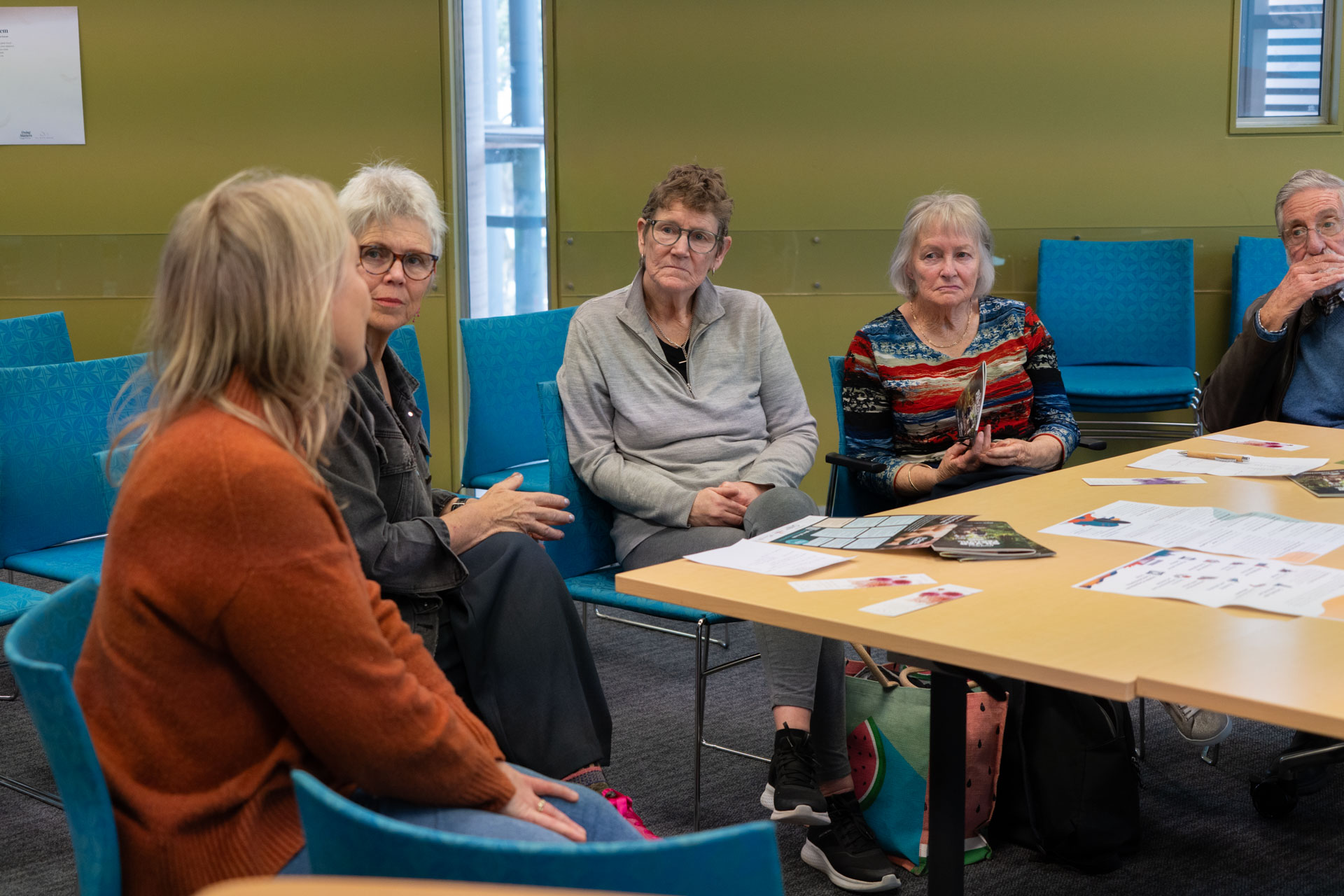 A group talking around a table in a library room